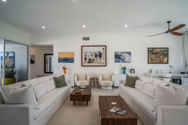 a living room with furniture and view of kitchen