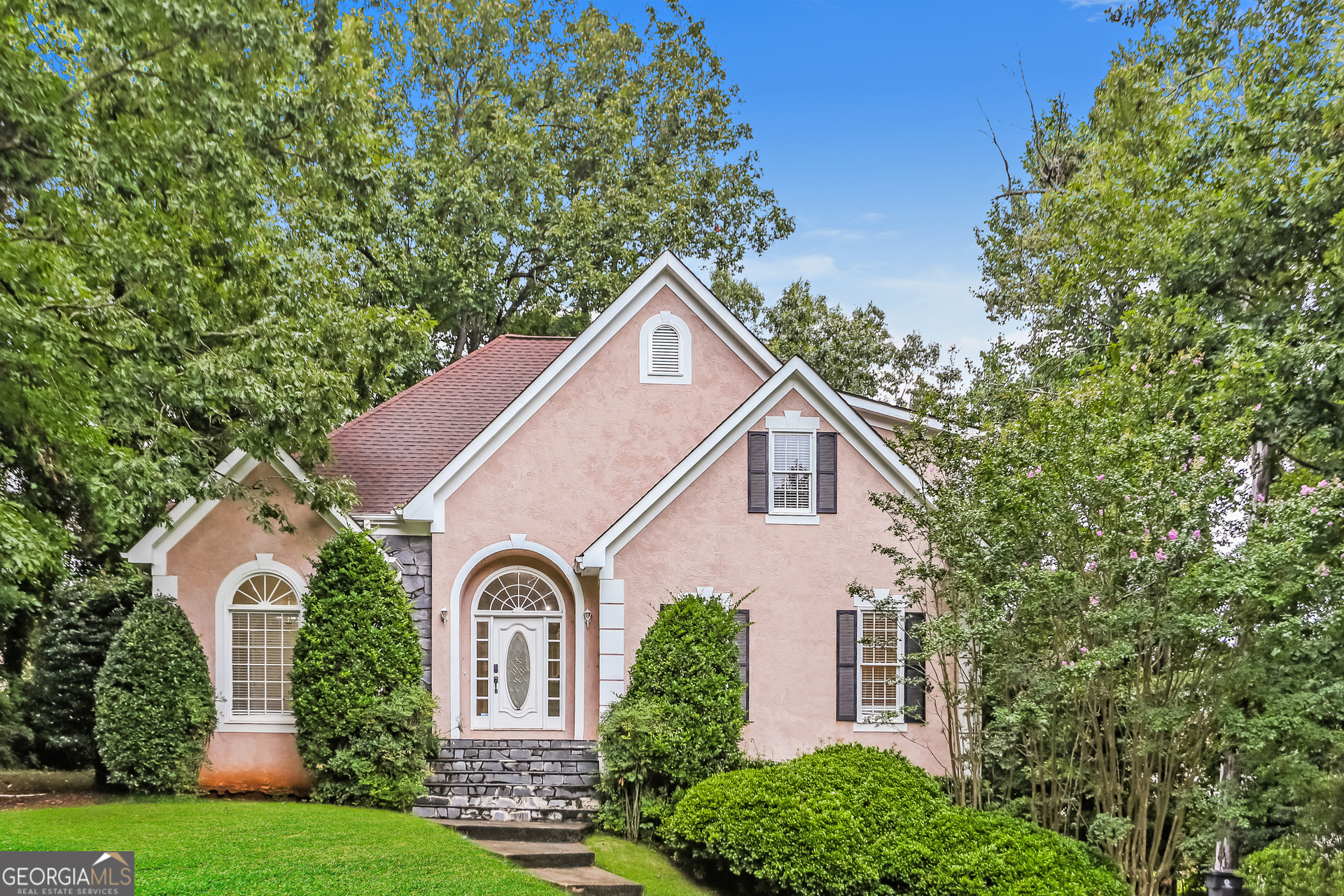 a front view of a house with garden
