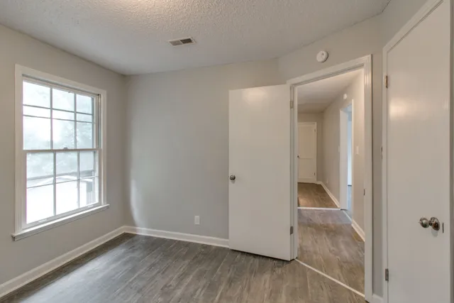 a view of a house with a tree in front of it
