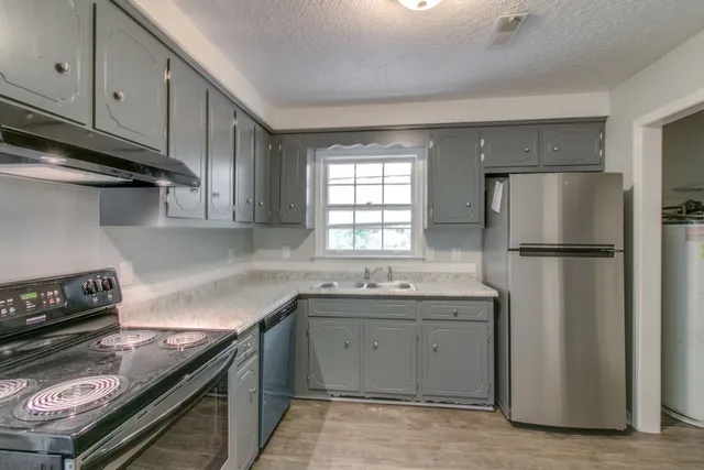 a kitchen with a sink and a refrigerator