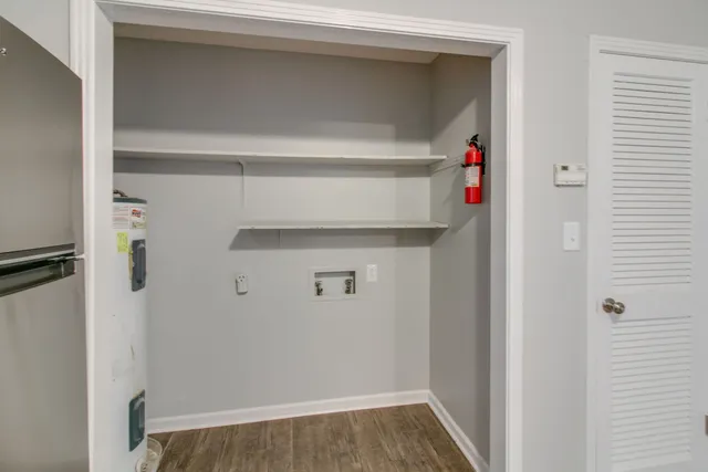 a view of hallway with wooden floor