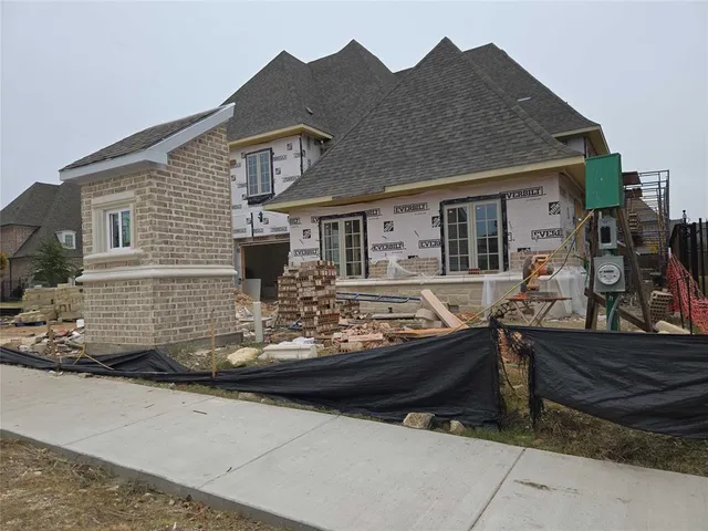 a front view of a house with sitting area