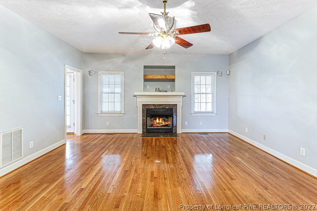 4051 Mt Tabor Road Red Springs, NC 28377 - Photo 21 of 50 a view of an empty room with wooden floor fireplace and a window