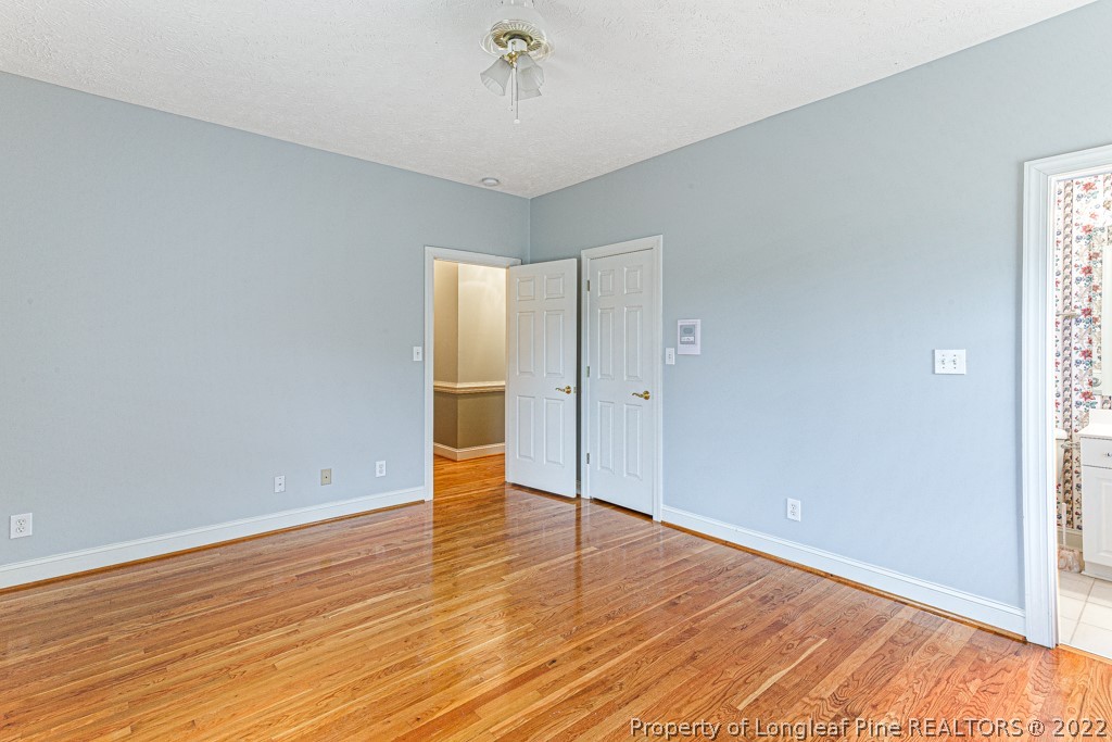 4051 Mt Tabor Road Red Springs, NC 28377 - Photo 26 of 50 an empty room with wooden floor and windows