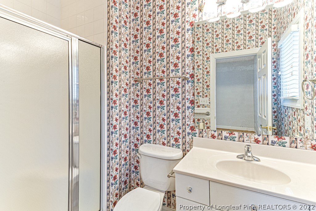 4051 Mt Tabor Road Red Springs, NC 28377 - Photo 27 of 50 a bathroom with a sink toilet and shower