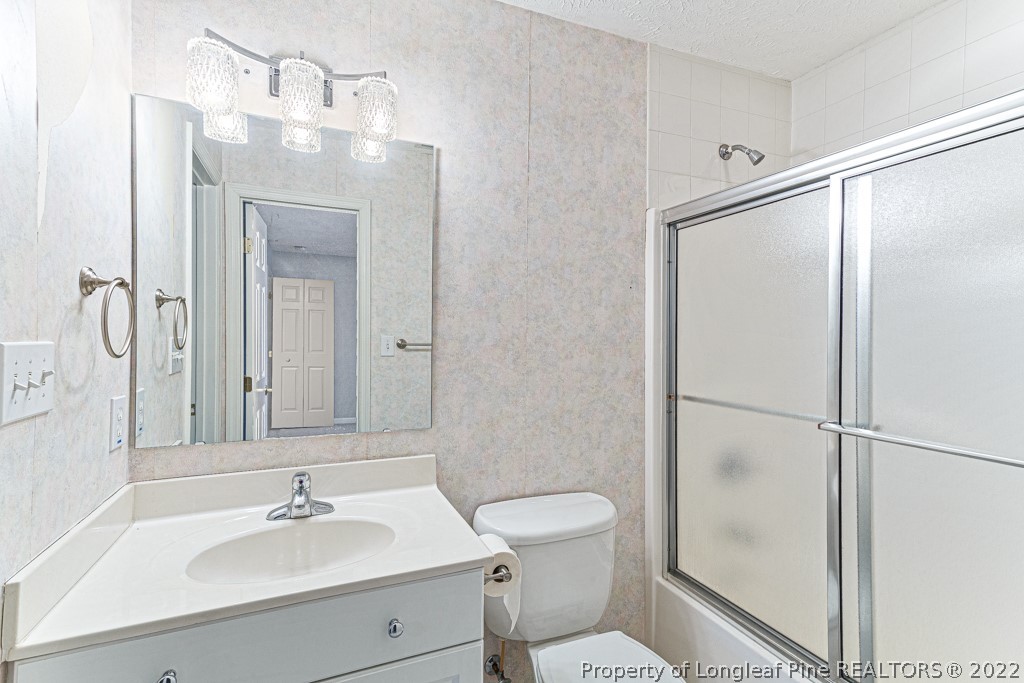 4051 Mt Tabor Road Red Springs, NC 28377 - Photo 38 of 50 a bathroom with a sink a toilet and shower