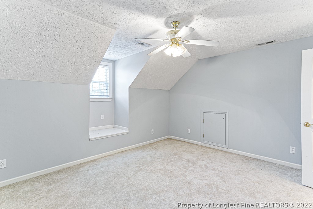 4051 Mt Tabor Road Red Springs, NC 28377 - Photo 40 of 50 an empty room with windows and fan chandelier fan