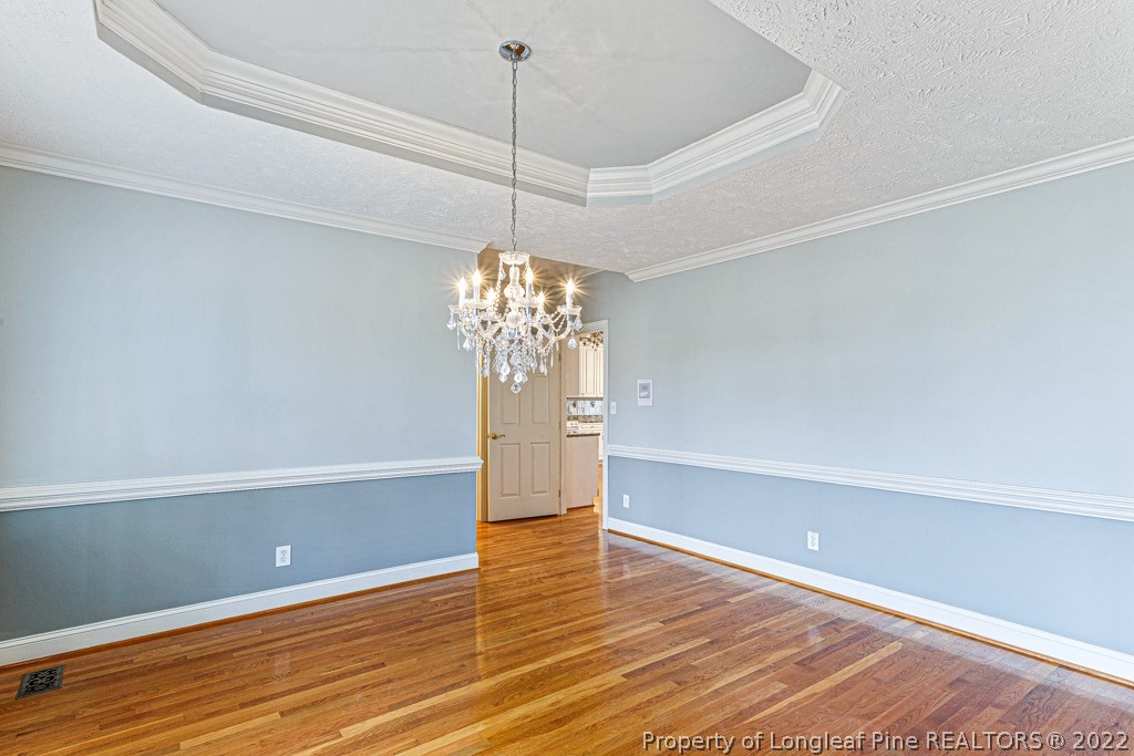 4051 Mt Tabor Road Red Springs, NC 28377 - Photo 7 of 50 a view of a room with wooden floor and chandelier