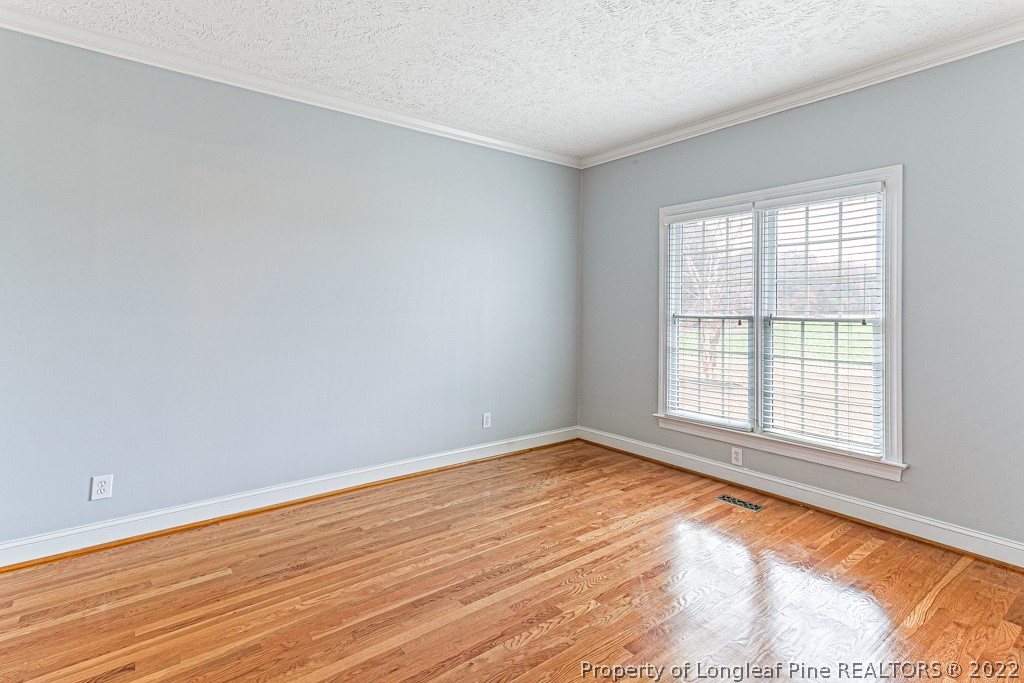 4051 Mt Tabor Road Red Springs, NC 28377 - Photo 9 of 50 a view of an empty room with wooden floor and a window