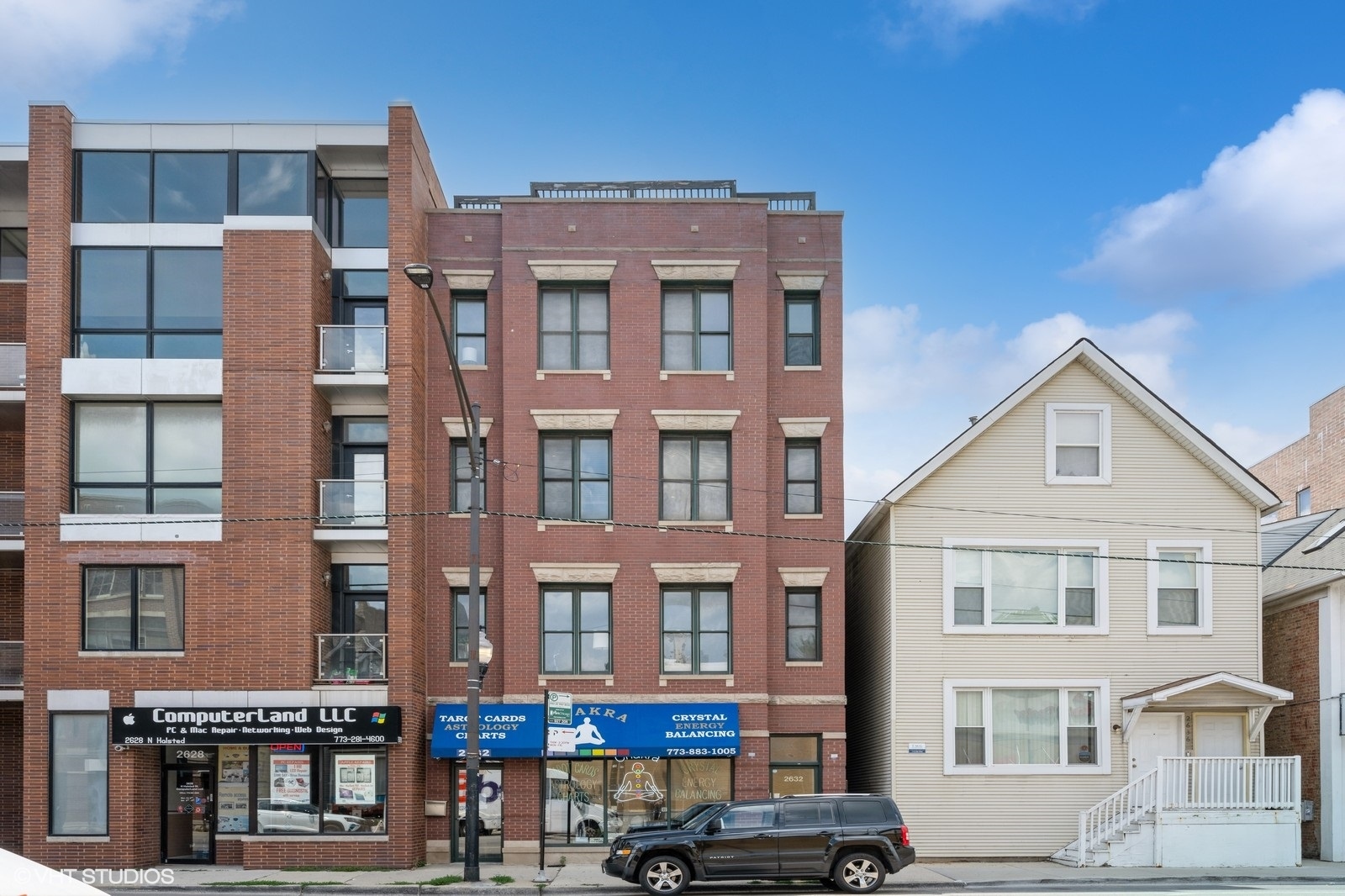2632 North Halsted Street, Unit 3 Chicago, IL 60614 - Photo 1 of 14 a front view of a residential apartment building with a yard
