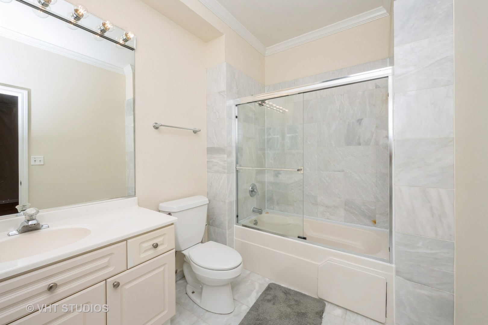 2632 North Halsted Street, Unit 3 Chicago, IL 60614 - Photo 11 of 14 a bathroom with a bathtub shower sink mirror and toilet