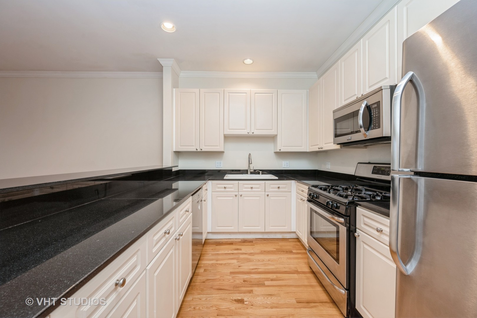 2632 North Halsted Street, Unit 3 Chicago, IL 60614 - Photo 4 of 14 a kitchen with stainless steel appliances granite countertop a stove a sink and a refrigerator