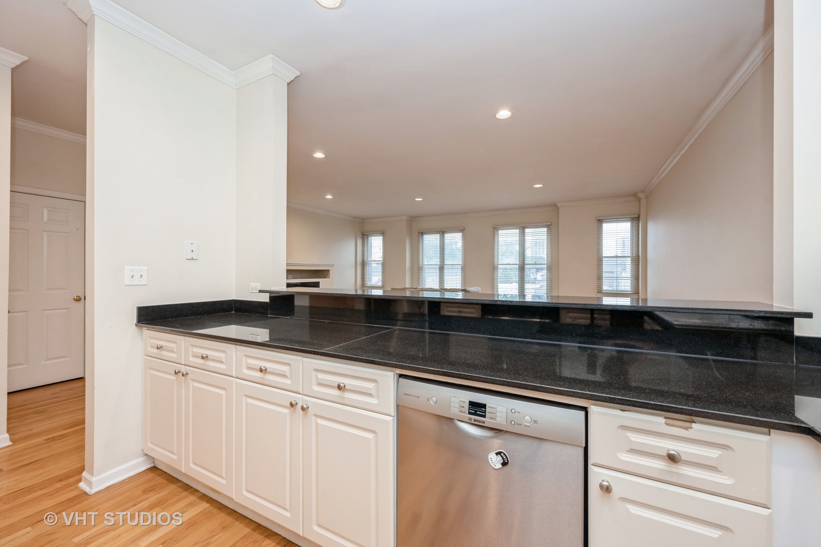 2632 North Halsted Street, Unit 3 Chicago, IL 60614 - Photo 5 of 14 a kitchen with granite countertop white cabinets and a sink