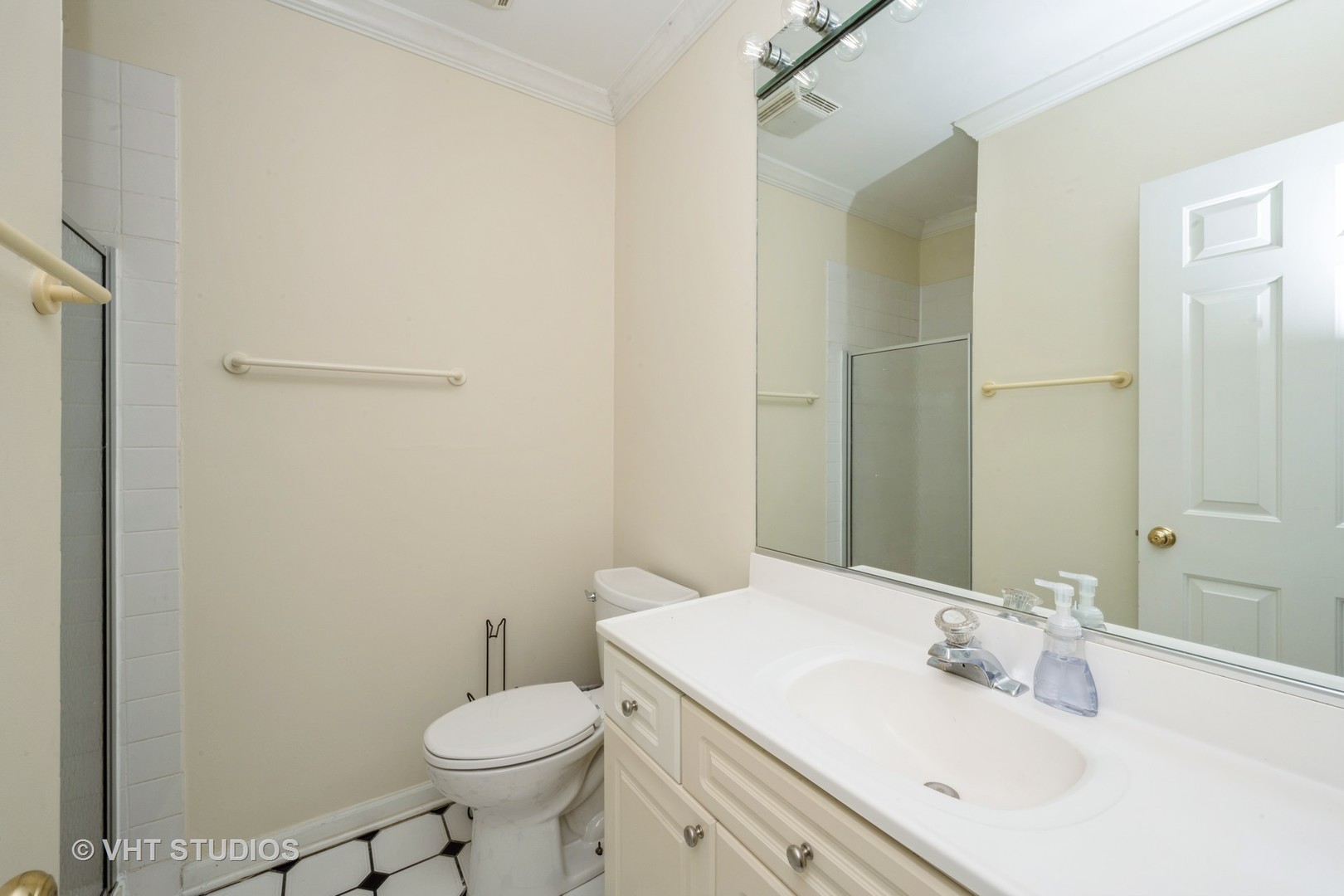 2632 North Halsted Street, Unit 3 Chicago, IL 60614 - Photo 10 of 14 a bathroom with a sink toilet and a mirror