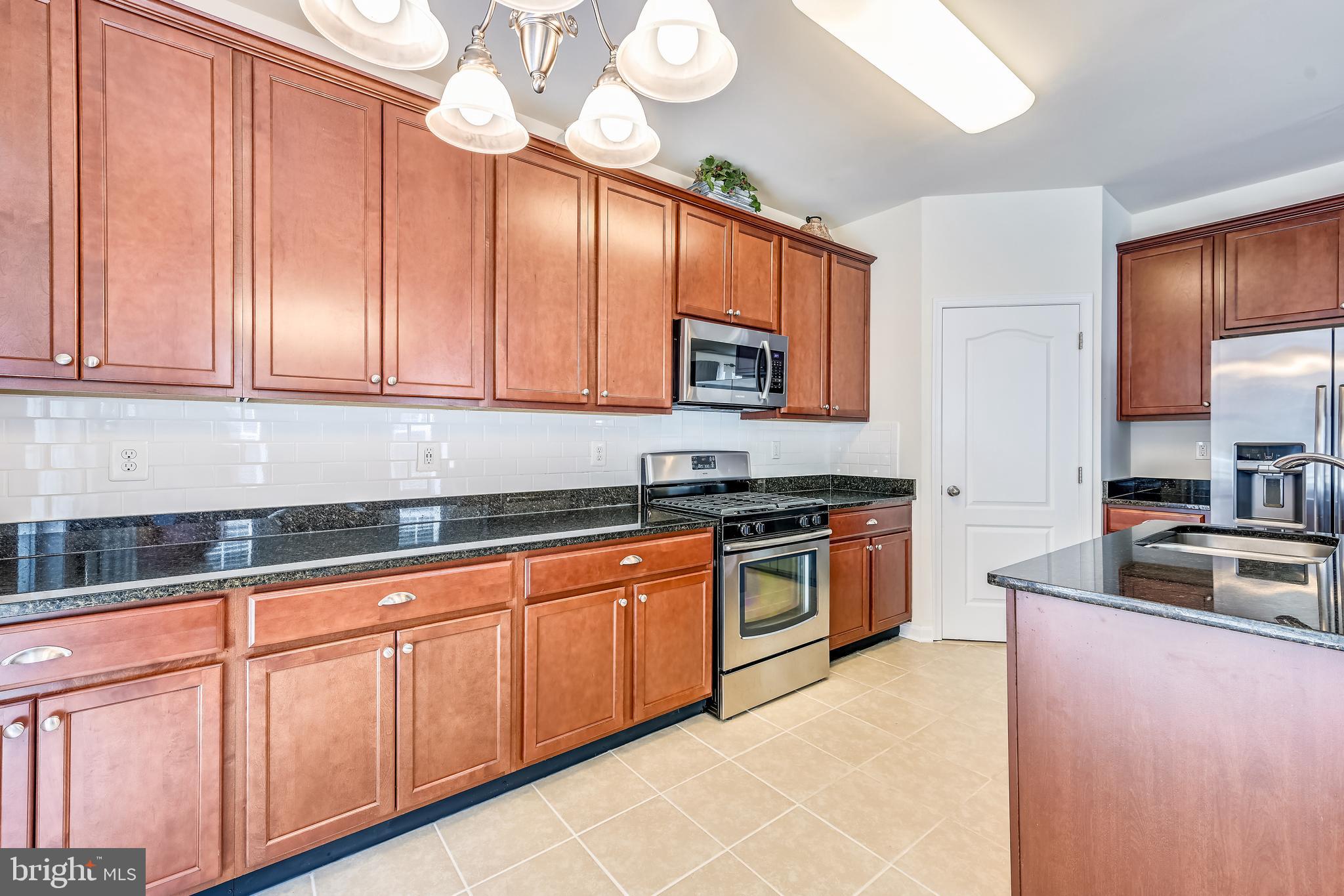 105 Jacobia Drive, Unit E4 Pasadena, MD 21122 - Photo 10 of 36 Stainless steel appliances and granite counters.