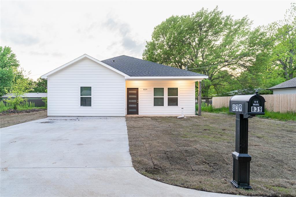 839 Southwest 7th Street Cooper, TX 75432 - Photo 10 of 21 View of front of property featuring driveway, roof with shingles, and fence