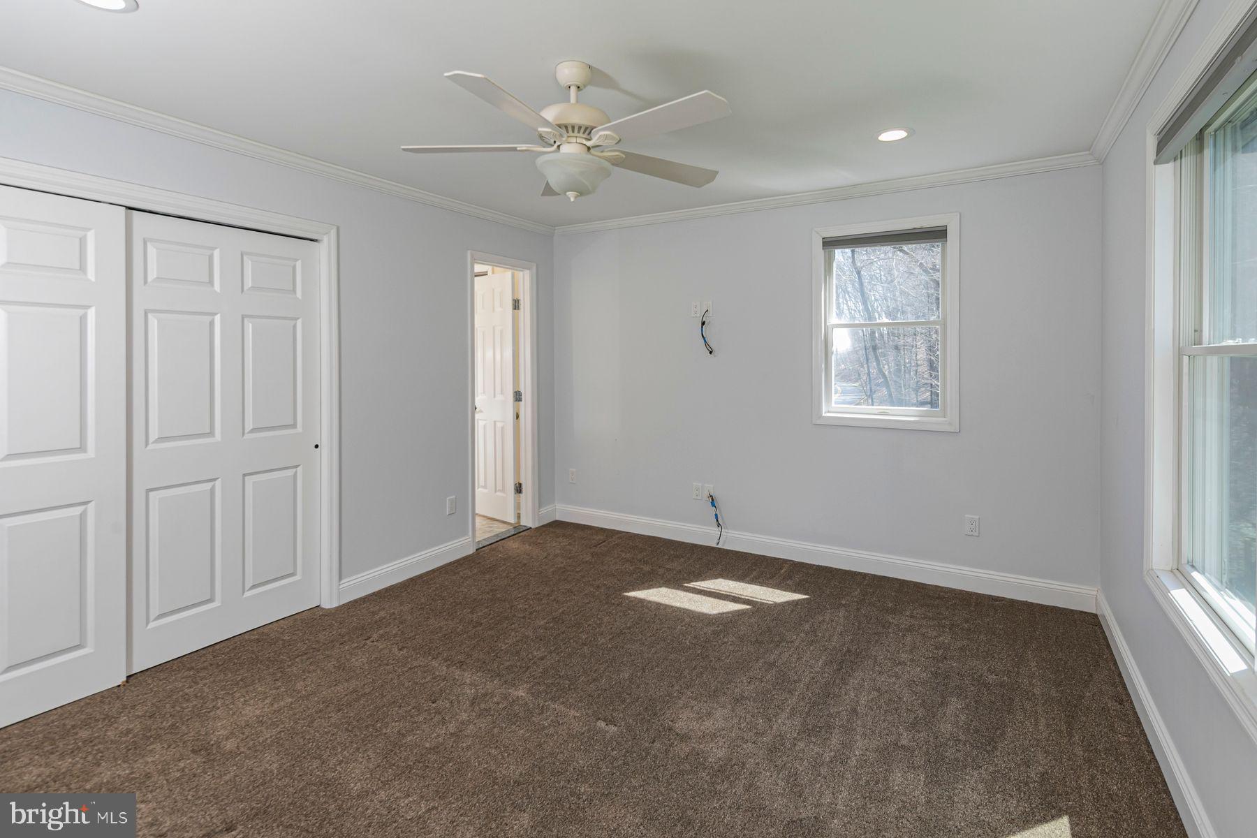310 Hollow Road Skillman, NJ 08558 - Photo 26 of 32 an empty room with windows and fan