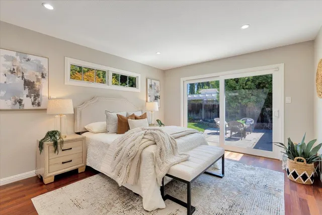 a bedroom with furniture and a large window