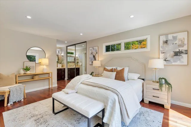 a bedroom with a bed and wooden floor