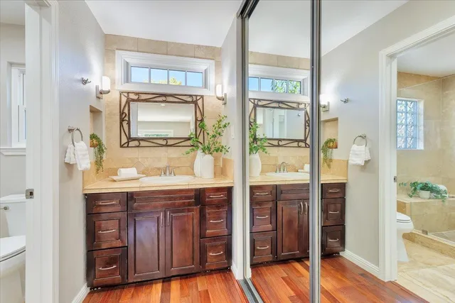 a bathroom with a sink a mirror and a shower
