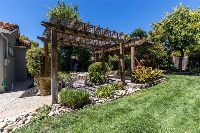a view of a house with a yard and tree s