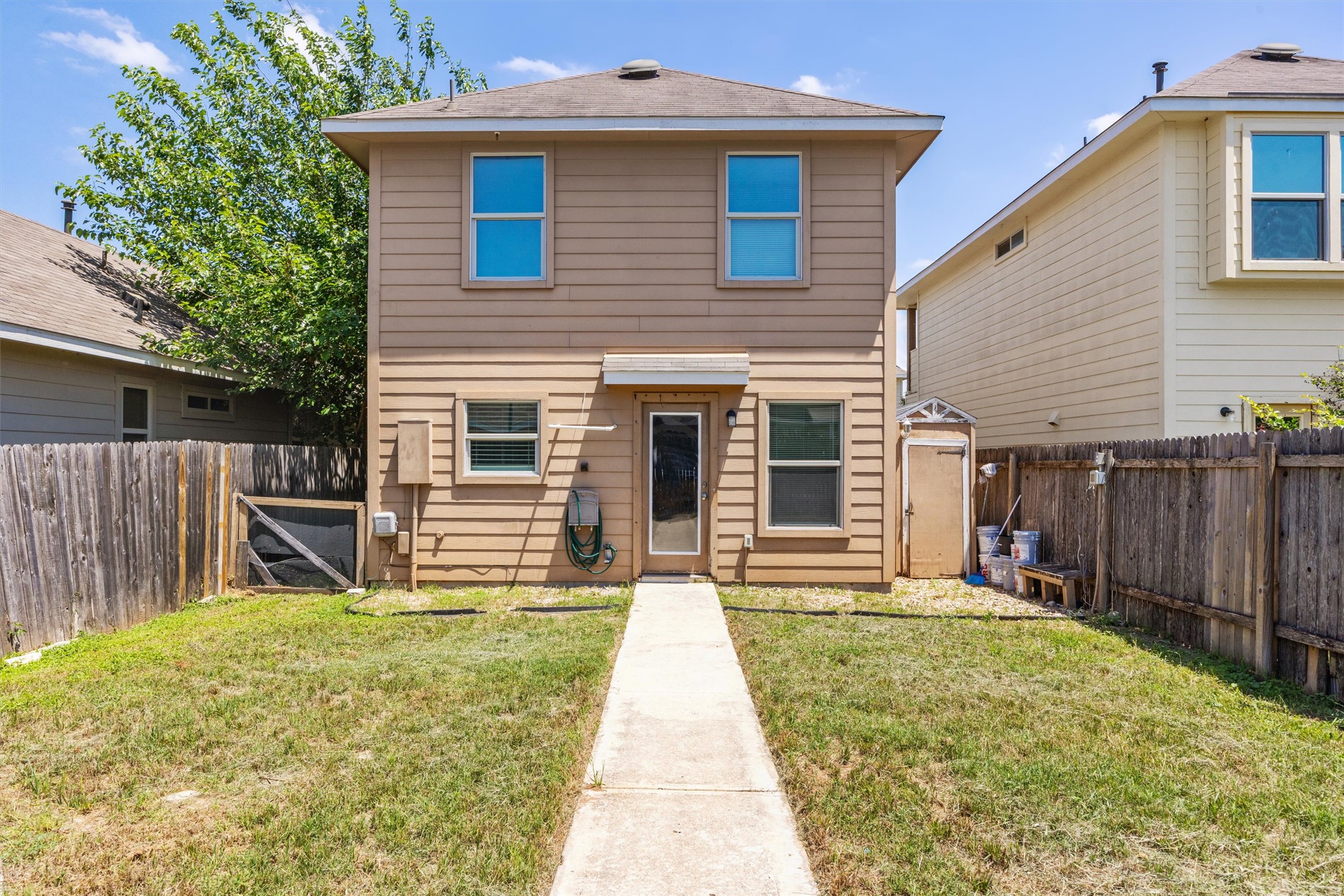 4516 Kind Way, Unit 253 Austin, TX 78725 - Photo 31 of 31 a view of a house with backyard and wooden fence