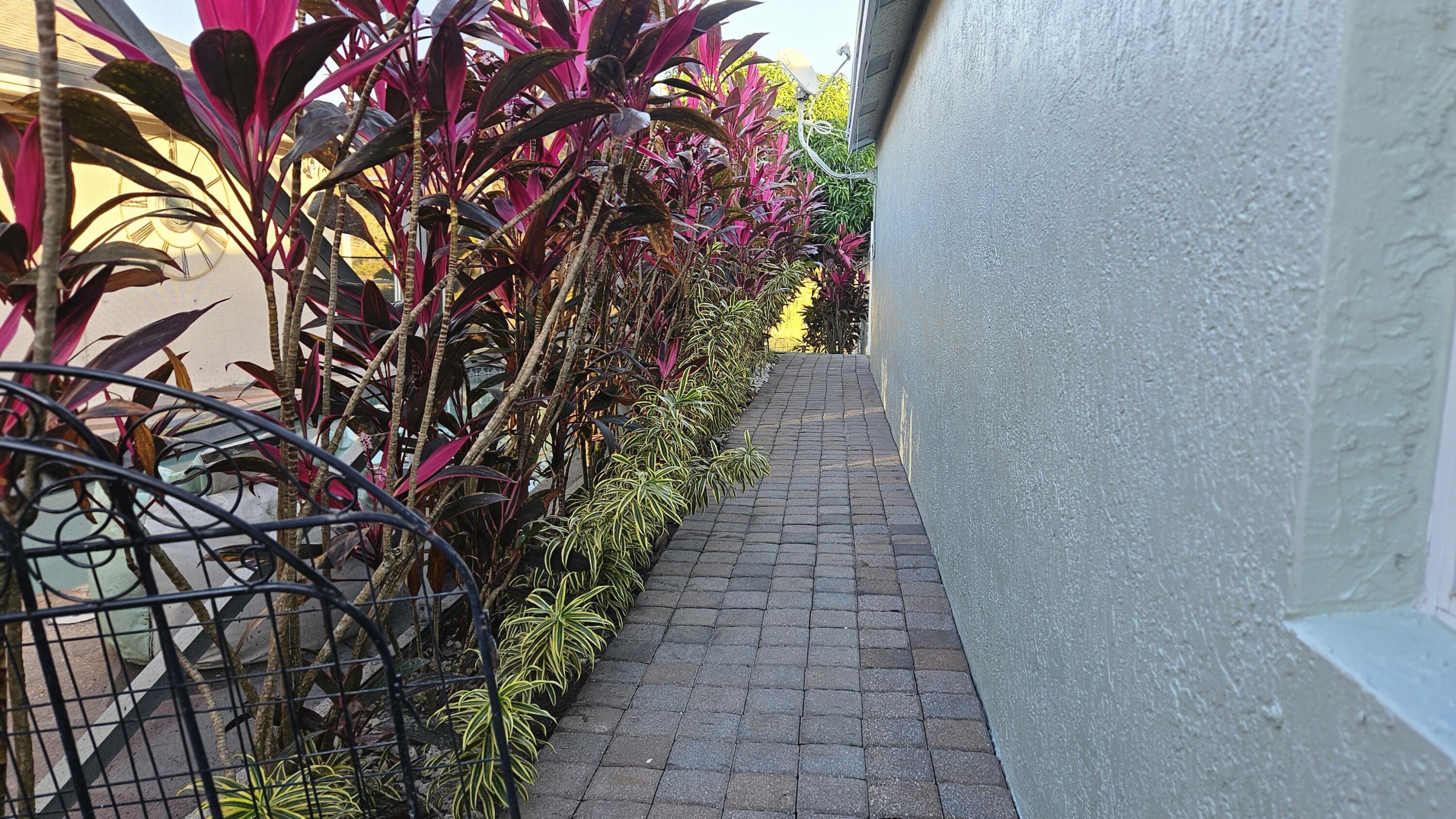 1768 Sawgrass Circle Greenacres, FL 33413 - Photo 11 of 40 a pathway with a yard