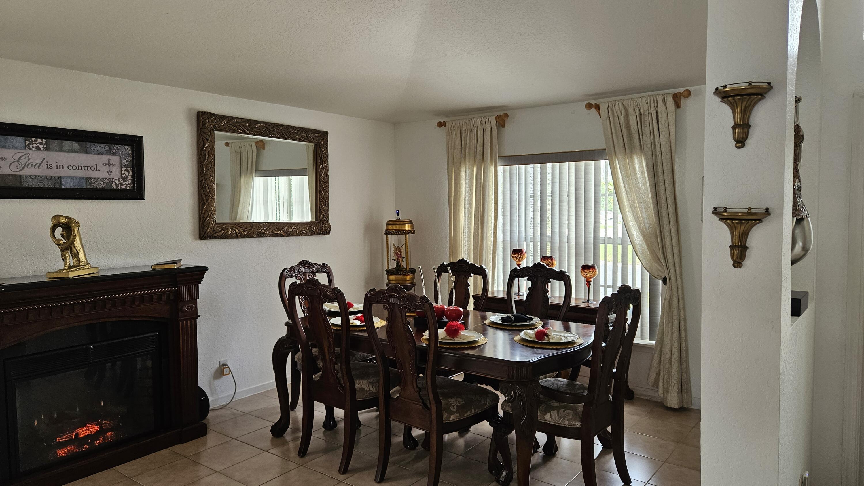 1768 Sawgrass Circle Greenacres, FL 33413 - Photo 21 of 40 a view of a a dining room with furniture window and wooden floor