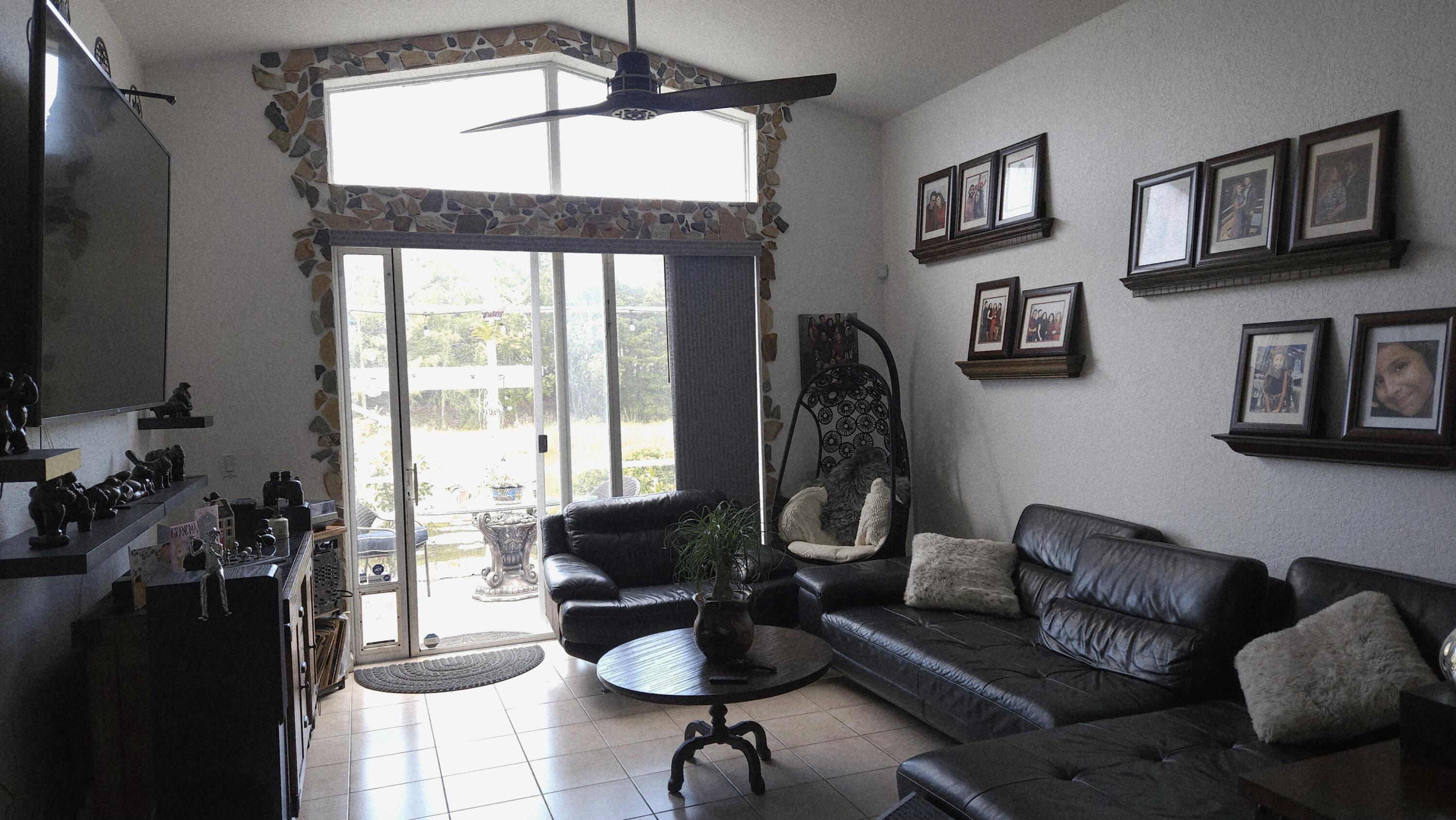 1768 Sawgrass Circle Greenacres, FL 33413 - Photo 22 of 40 a living room with furniture and a flat screen tv