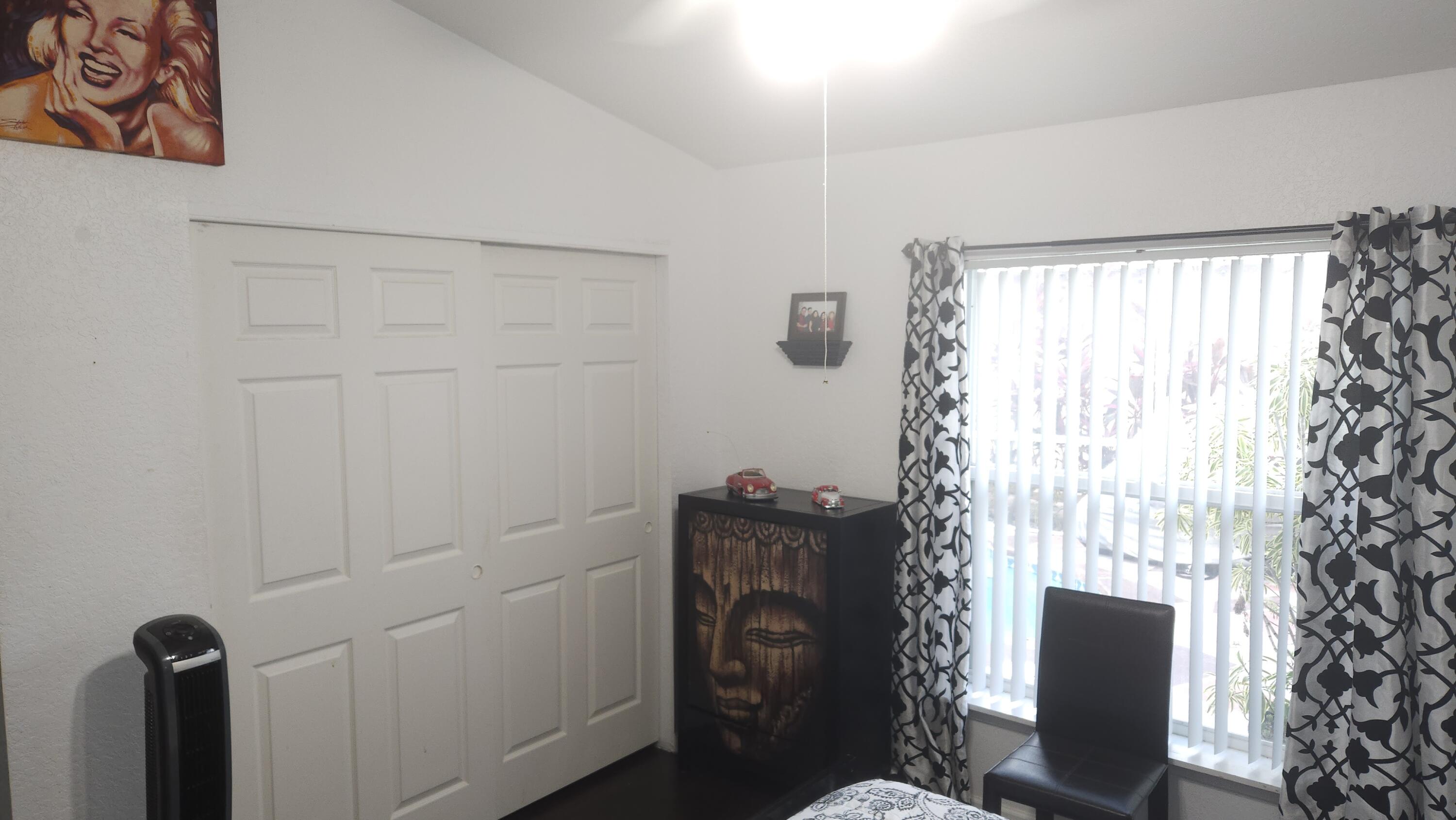 1768 Sawgrass Circle Greenacres, FL 33413 - Photo 28 of 40 a bathroom with a toilet and a shower curtain