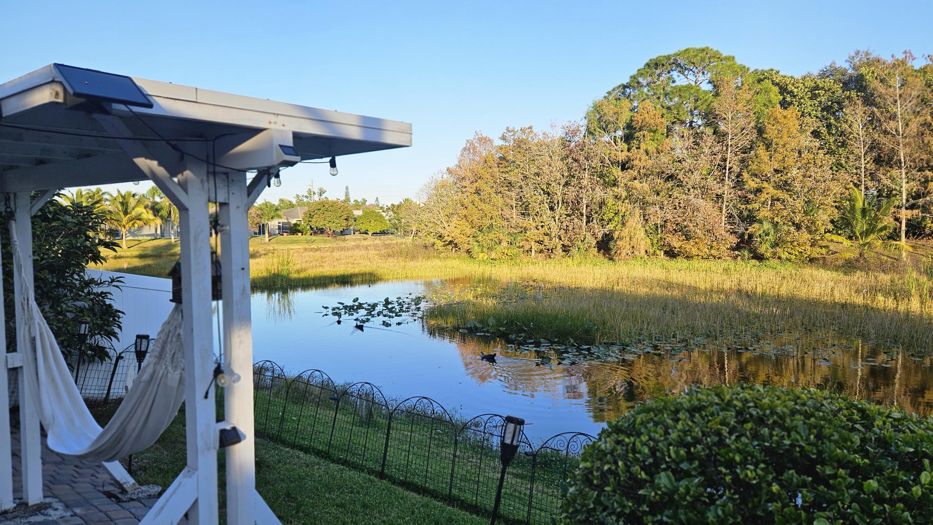 1768 Sawgrass Circle Greenacres, FL 33413 - Photo 3 of 40 a view of a lake from a yard