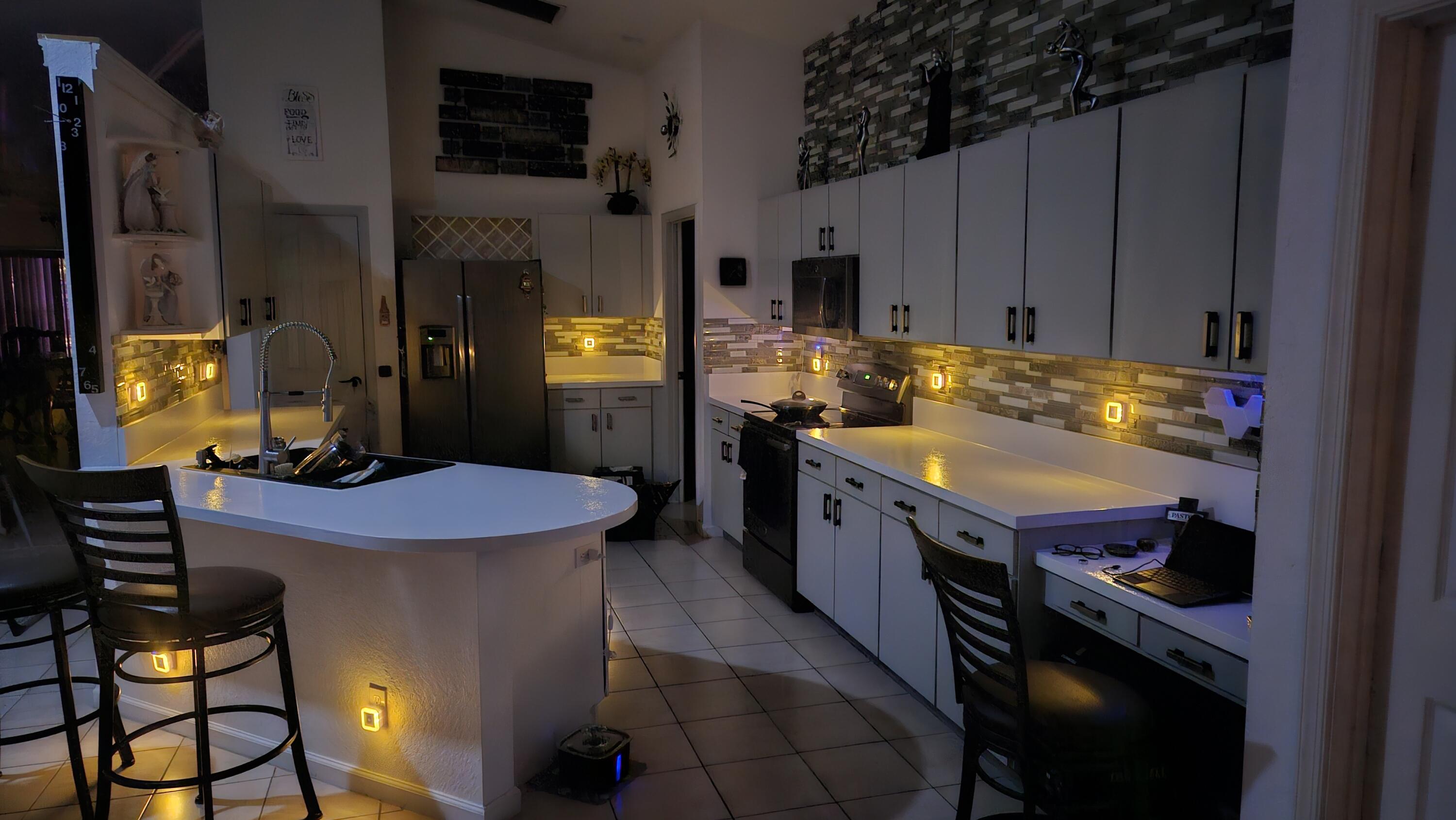 1768 Sawgrass Circle Greenacres, FL 33413 - Photo 32 of 40 a kitchen with a stove a refrigerator and a dining table