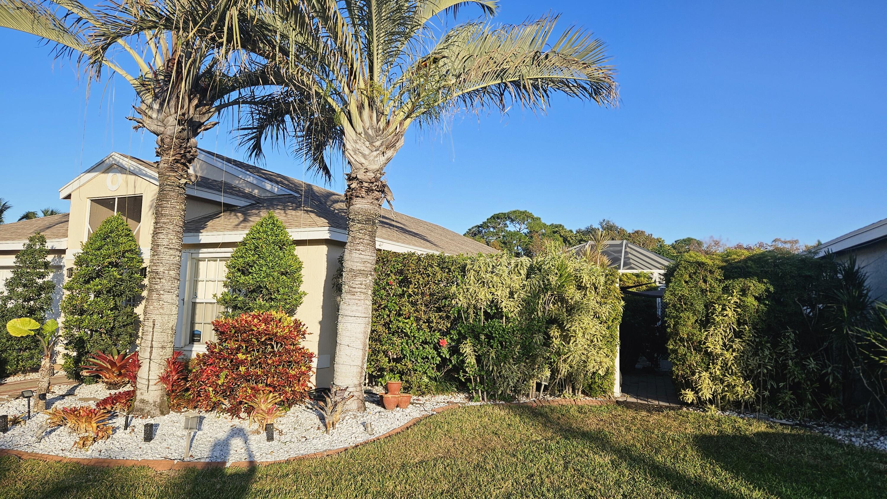 1768 Sawgrass Circle Greenacres, FL 33413 - Photo 34 of 40 a view of a house with a yard and potted plants