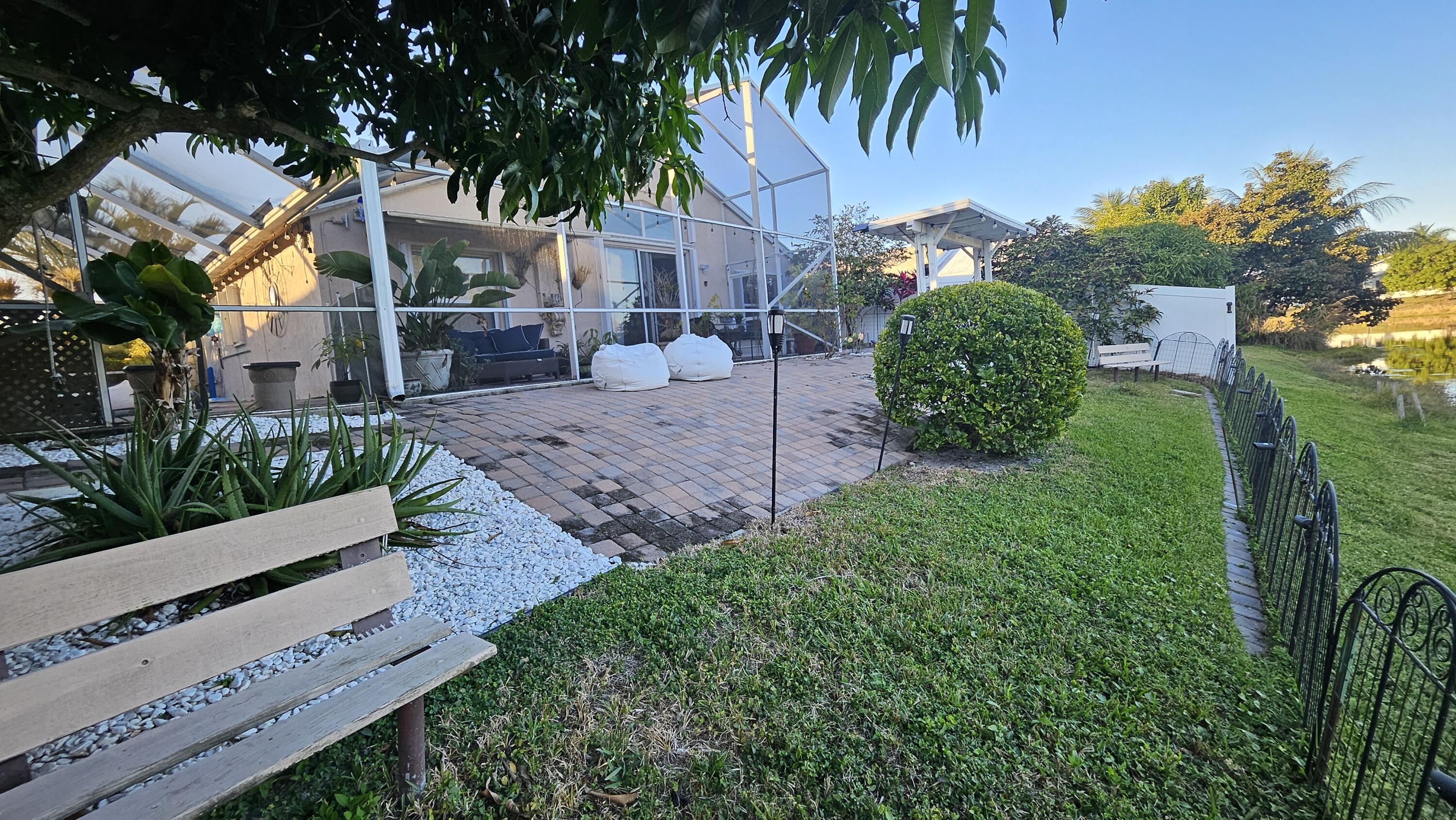 1768 Sawgrass Circle Greenacres, FL 33413 - Photo 9 of 40 a view of a garden with a house