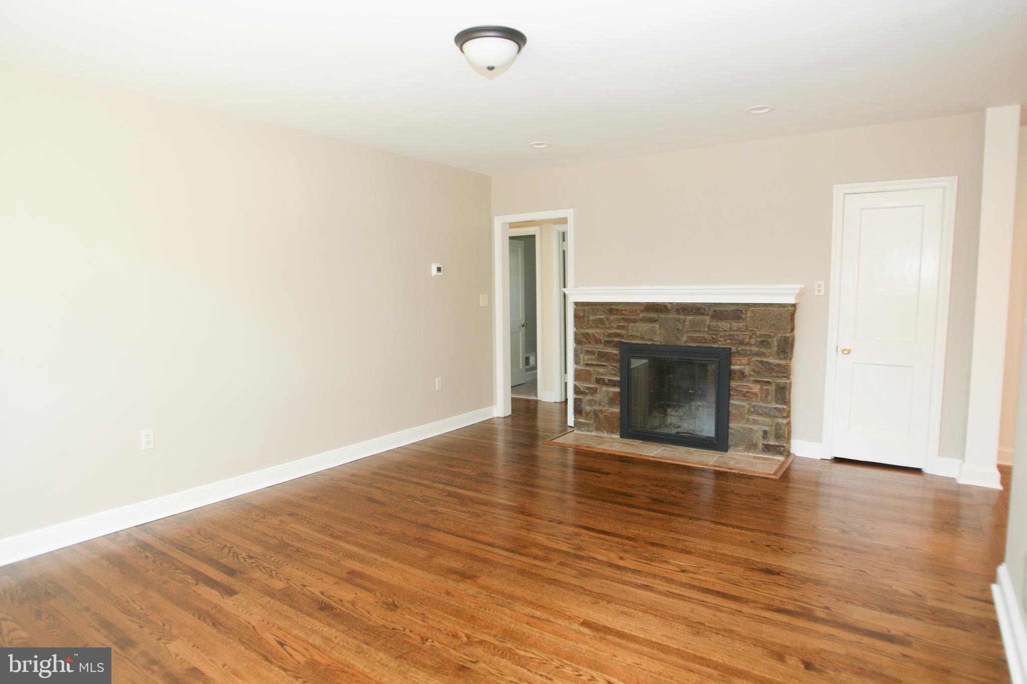 13 Windsor Road Wilmington, DE 19809 - Photo 4 of 37 Living Room with original stone fireplace