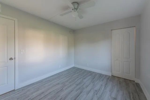 a view of an empty room with wooden floor