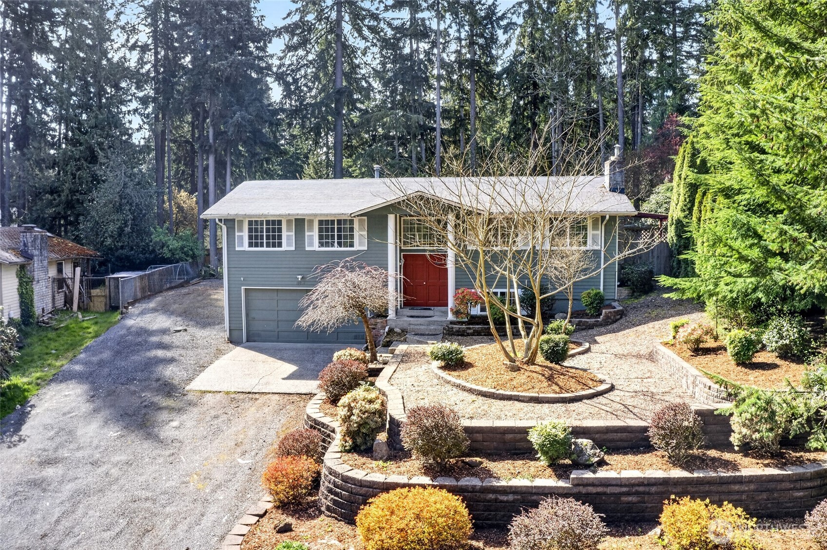 19010 63rd Street East Lake Tapps, WA 98391 - Photo 2 of 32 a view of a patio with table and chairs potted plants and large tree