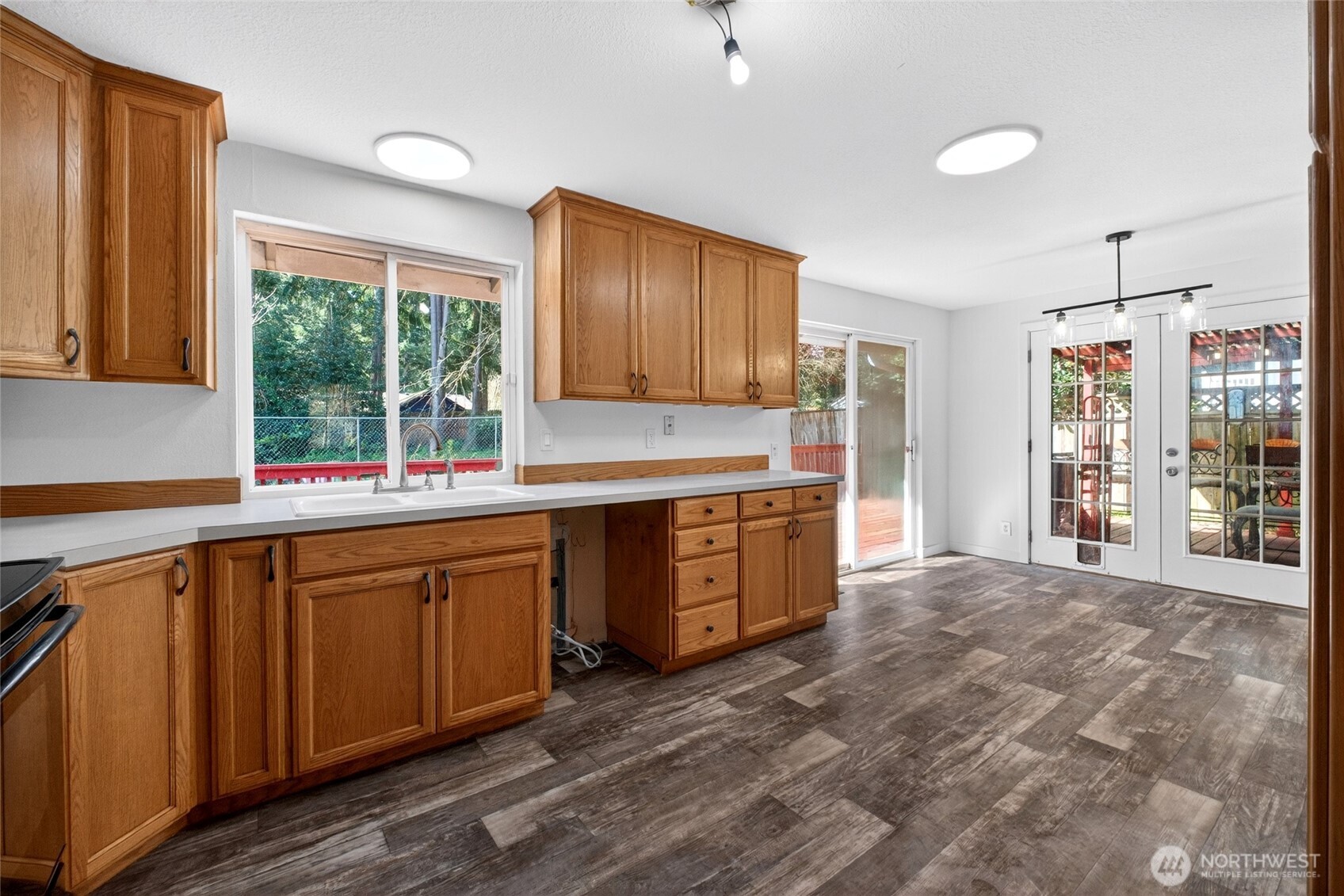 19010 63rd Street East Lake Tapps, WA 98391 - Photo 23 of 32 a kitchen with stainless steel appliances granite countertop a stove a sink and a refrigerator with cabinets