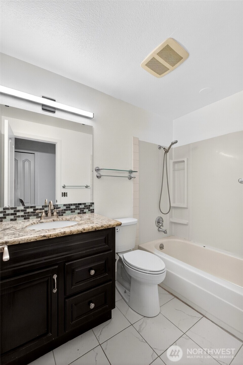 19010 63rd Street East Lake Tapps, WA 98391 - Photo 24 of 32 a bathroom with a sink vanity mirror and toilet