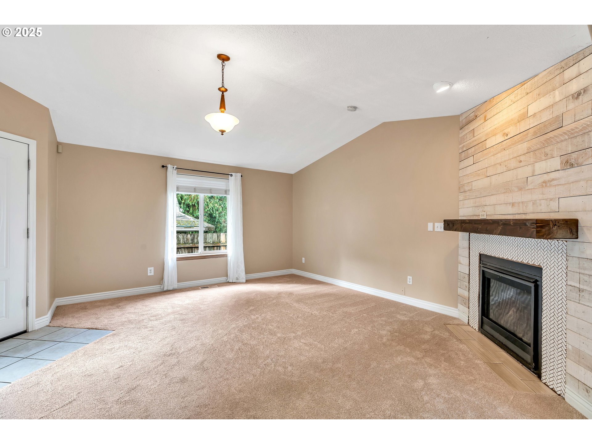 8 Elm Street Ridgefield, WA 98642 - Photo 8 of 33 a view of an empty room with a fireplace and a window