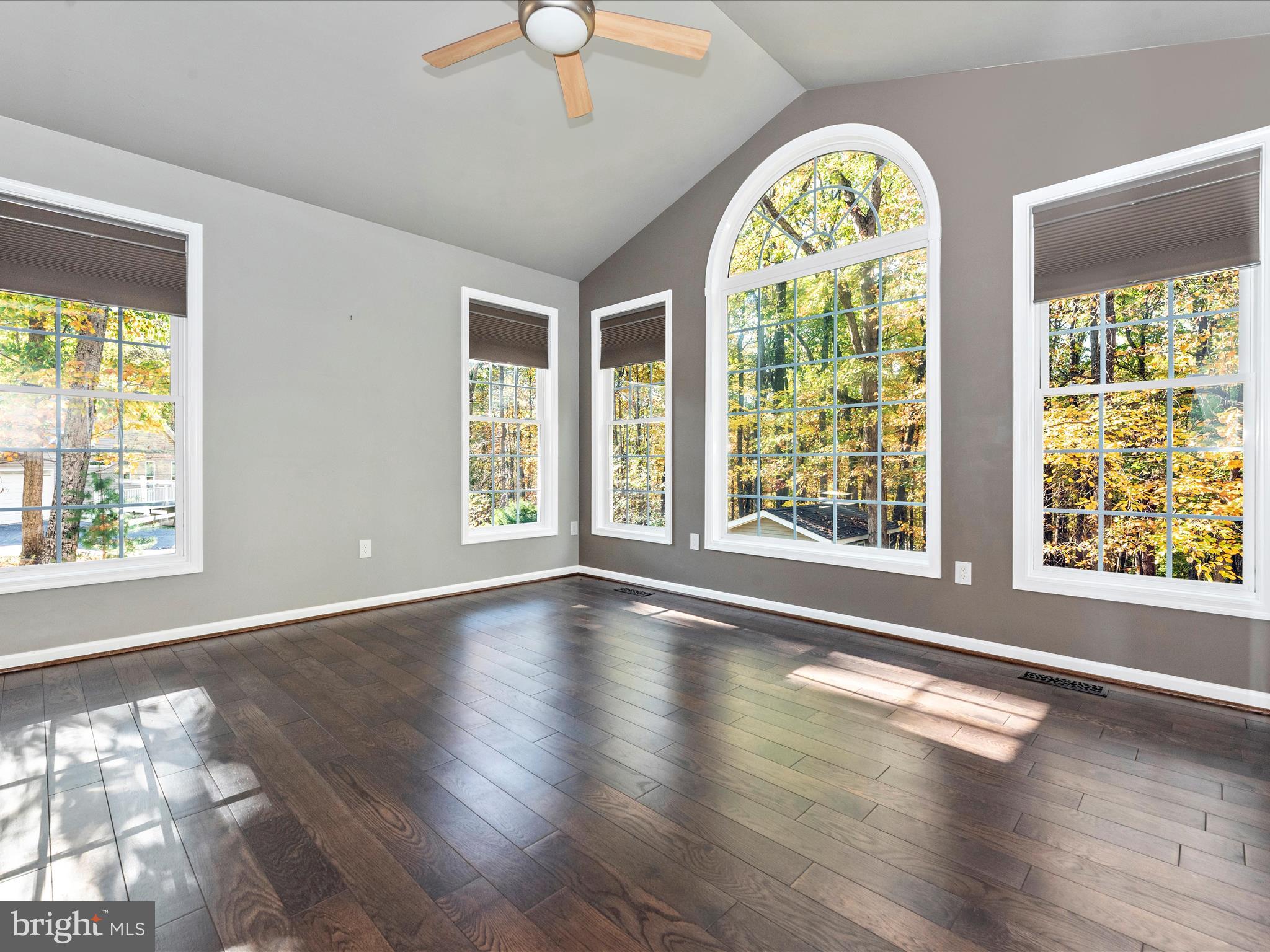10027 Pine Tree Road Woodsboro, MD 21798 - Photo 12 of 81 a view of an empty room with wooden floor windows and a chandelier