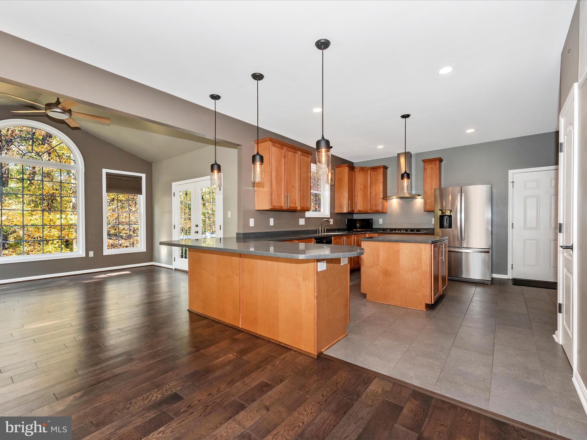 10027 Pine Tree Road Woodsboro, MD 21798 - Photo 17 of 81 a large kitchen with granite countertop a large counter top stainless steel appliances and windows