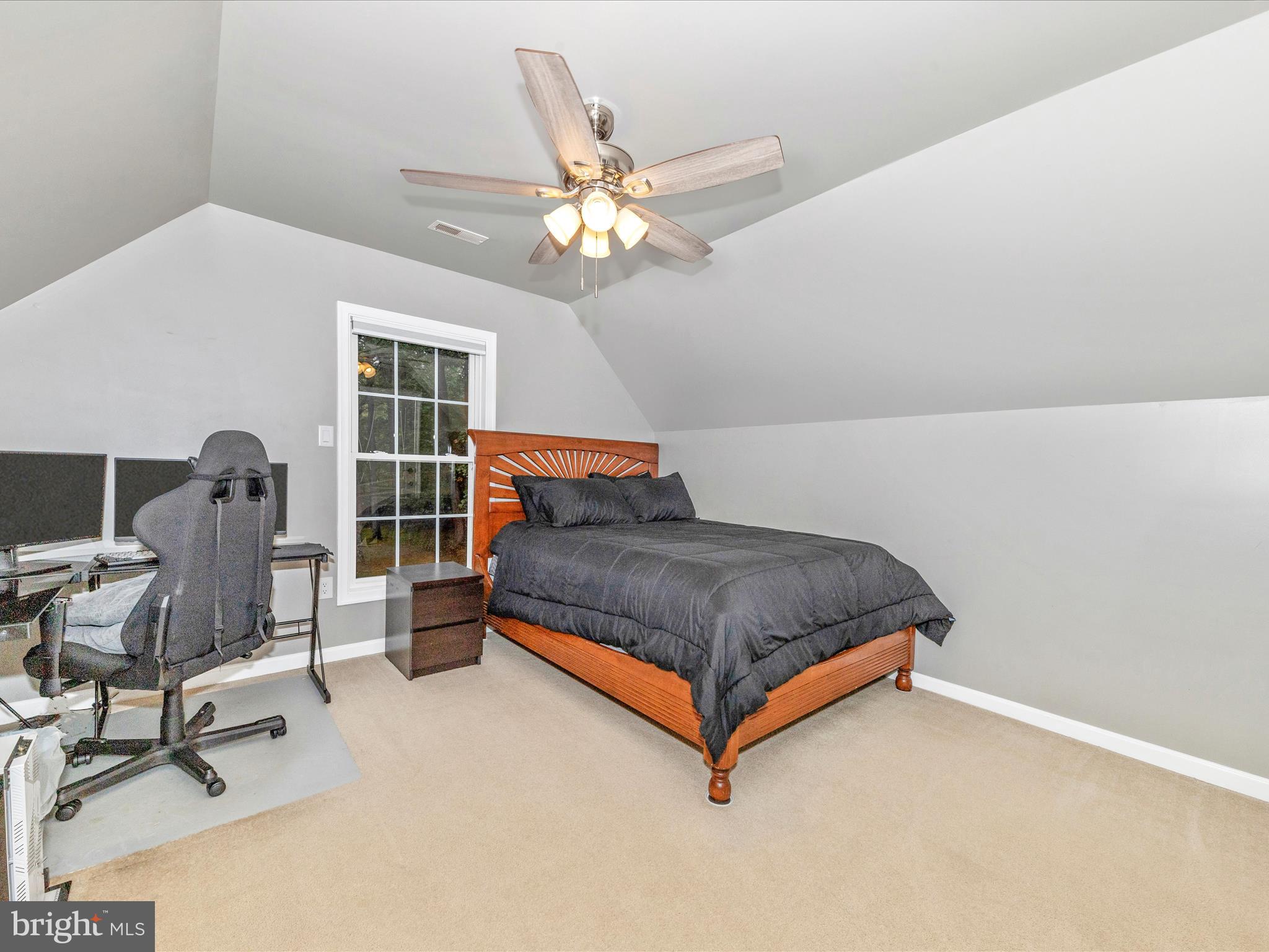 10027 Pine Tree Road Woodsboro, MD 21798 - Photo 57 of 81 a bedroom with a bed and a chandelier