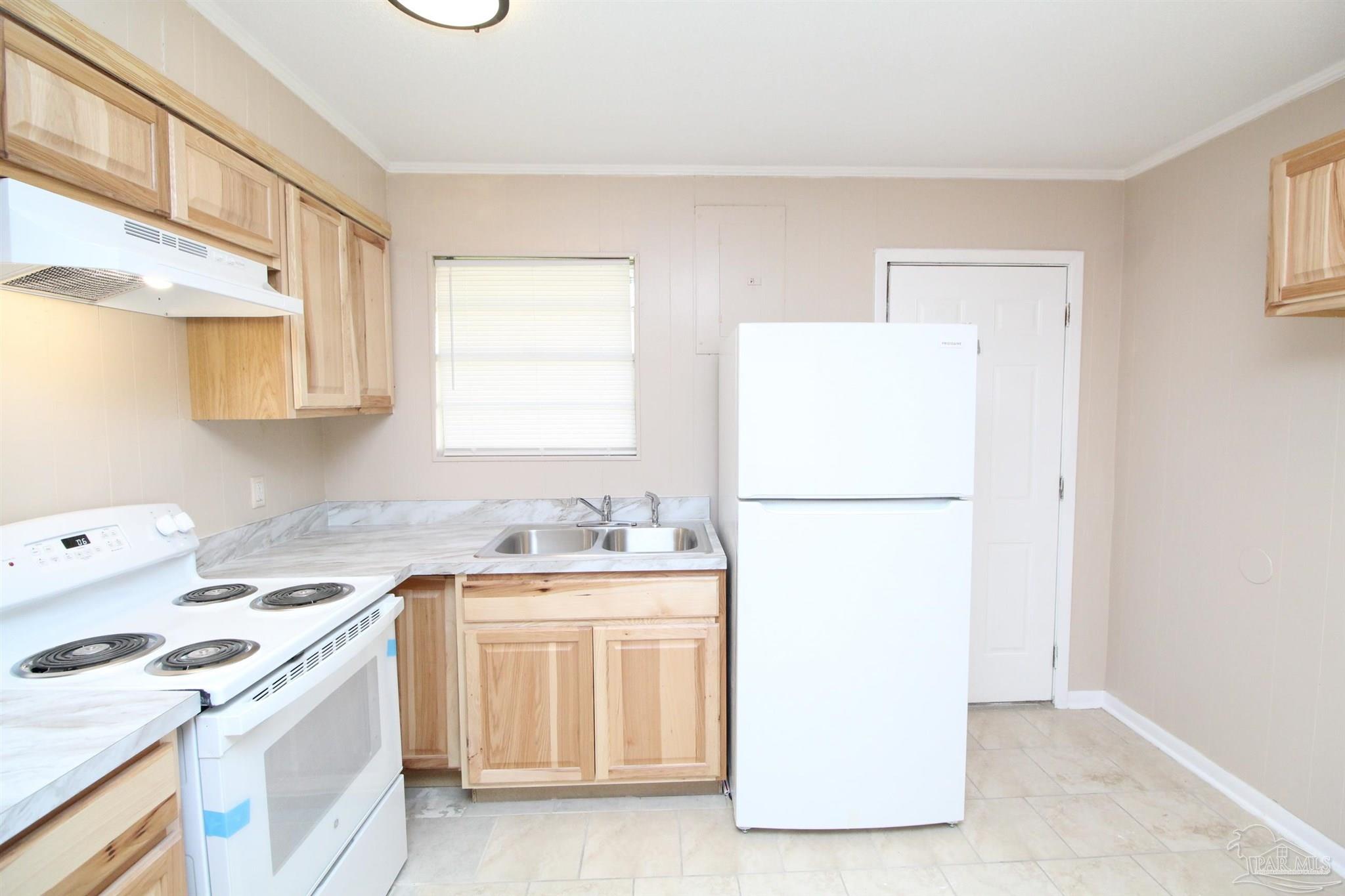 6620 Applegate Street Milton, FL 32570 - Photo 7 of 12 a kitchen with a refrigerator sink stove and cabinets
