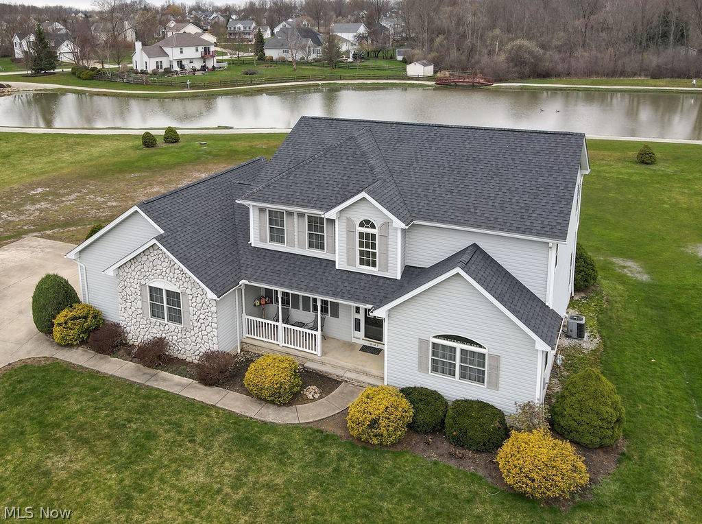 10147 Page Road Streetsboro, OH 44241 - Photo 35 of 35 View of front of house featuring covered porch, a water view, and a front lawn