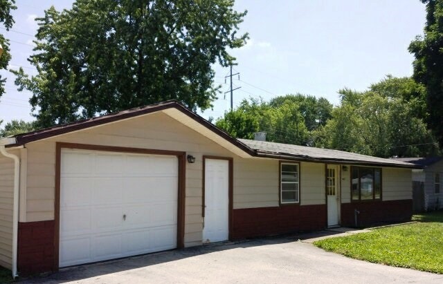 7407 Mildred Road Machesney Park, IL 61115 - Photo 2 of 10 a front view of house with yard and trees in the background