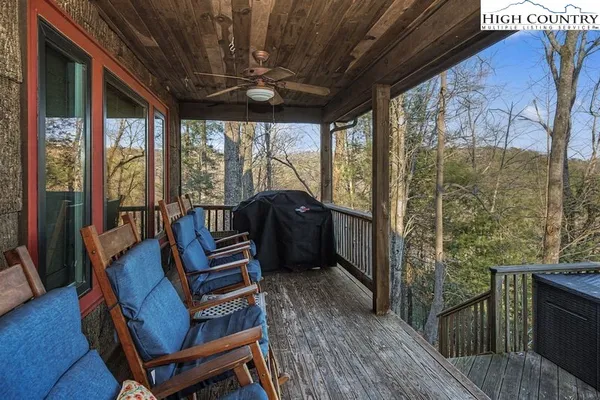 a view of a balcony with furniture and wooden floor