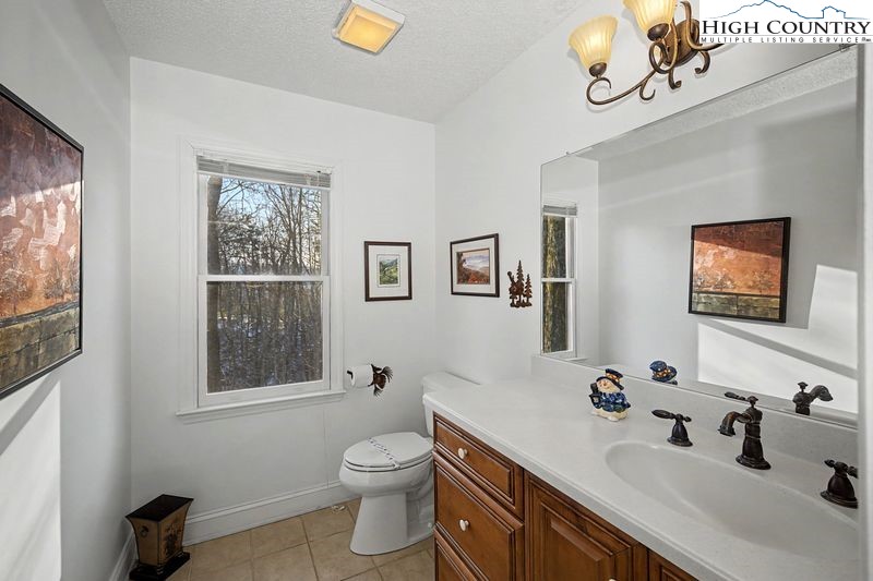 137 Granny's Ridge Road Ferguson, NC 28624 - Photo 13 of 27 a bathroom with a sink mirror and toilet