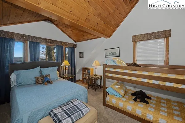 a bedroom with furniture and a lamp