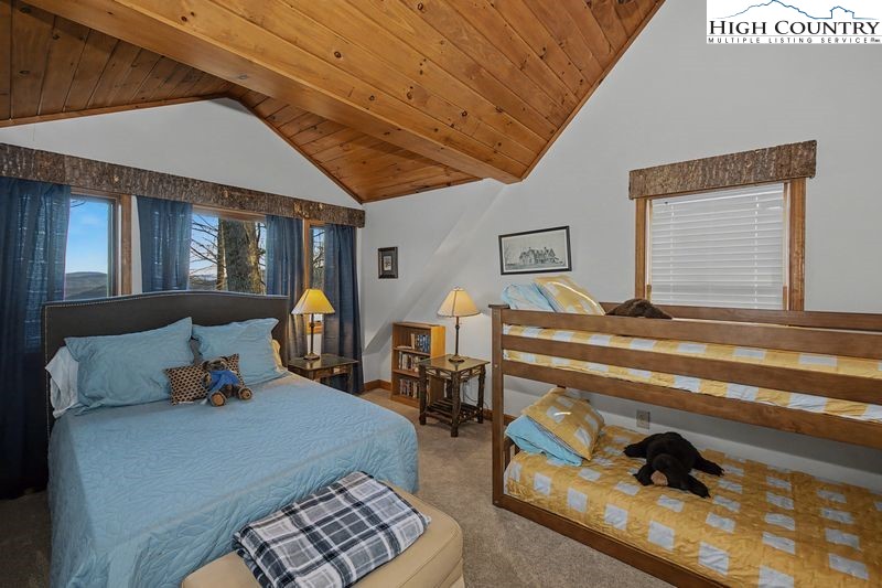 137 Granny's Ridge Road Ferguson, NC 28624 - Photo 17 of 27 a bedroom with furniture and a lamp